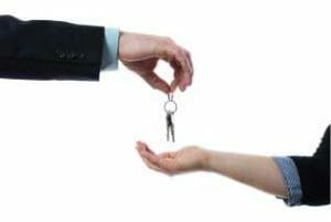 Two hands exchanging keys