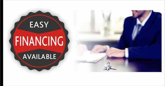 man sitting at desk with keys on a table and message Easy Financing Available
