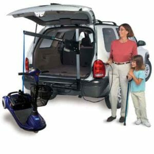 lady with child standing and operating the Harmar AL065 mobility scooter lift installed inside their white SUV