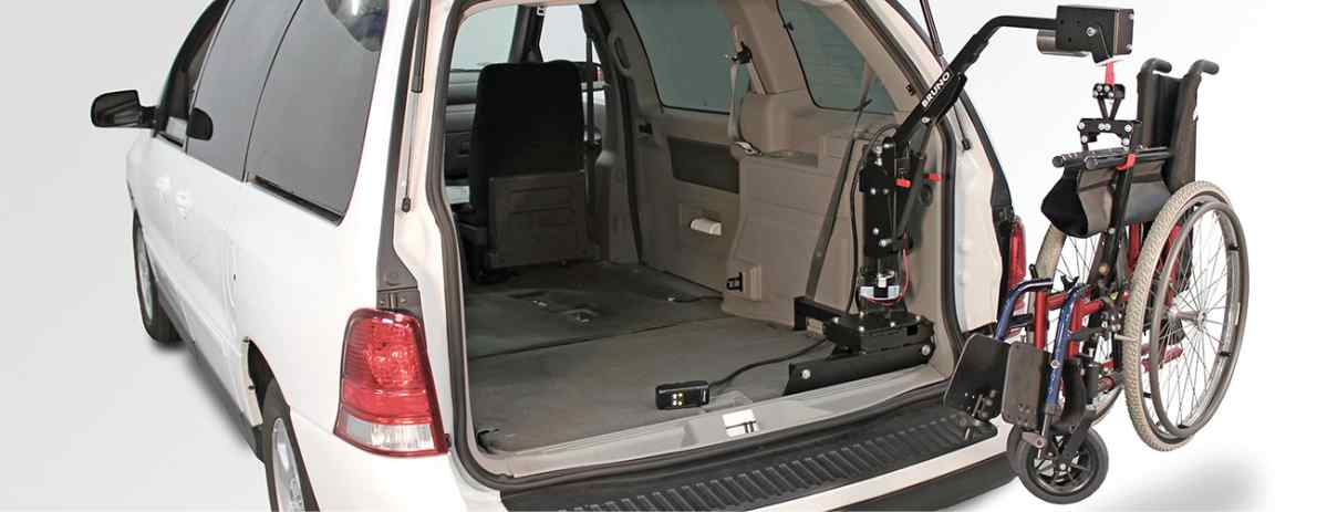 Bruno Lifter Manual wheelchair lift installed inside rear hatch of white minivan