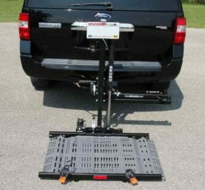 Black Ford Expedition with a Bruno Out-Side scooter carrier attached to trailer hitch