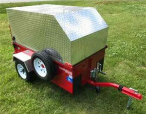 Image of a red scootatrailer with chrome topper sitting on green grass