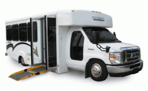 White , ADA paratransit vehicle with wheelchair lift deployed from side door