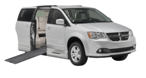 image of a silver Dodge Caravan wheelchair van with ramp out