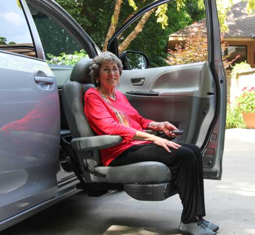 lady sitting in a turny evo mobility seat in a van