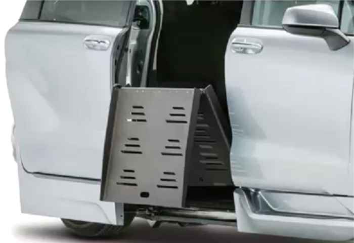 Closeup of fold-out wheelchair ramp on silver handicap van