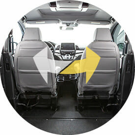 image of inside a VMI Wheelchair van with arrows showing how the two front seats can be moved from one side to the other