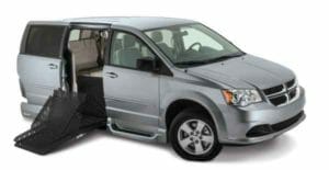 Silver Dodge Caravan with a VMI Summit, fold-out wheelchair van conversion.