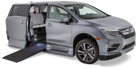 Silver Honda Odyssey Wheelchair van with its ramp out from Vantage Mobility.